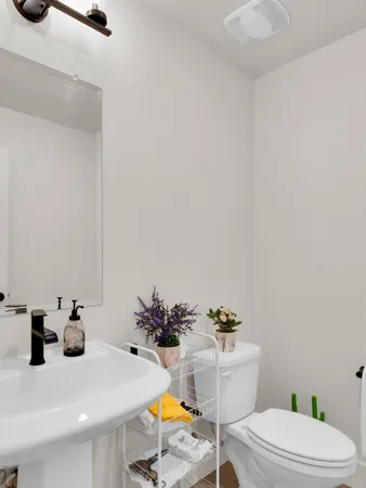 a bathroom with a sink toilet and mirror