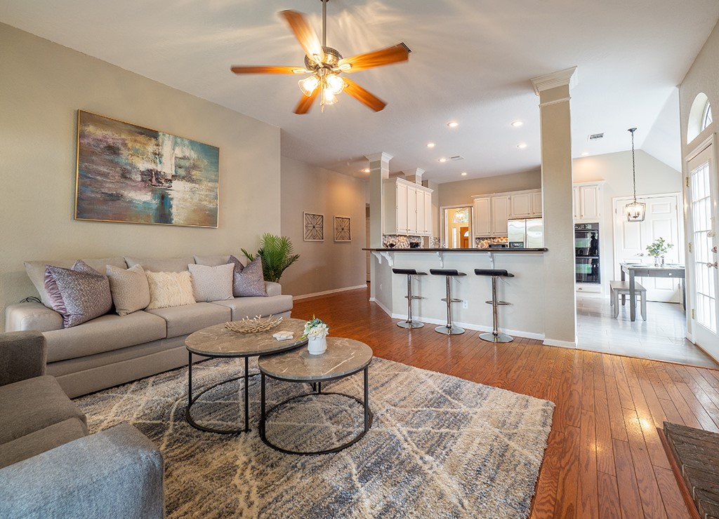 a living room with furniture and kitchen view