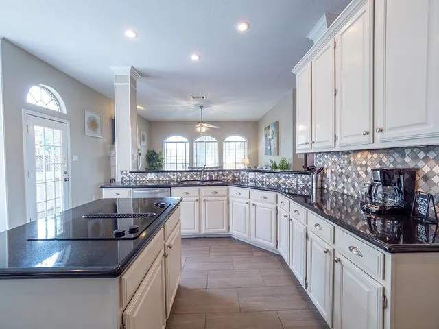 a kitchen with stainless steel appliances granite countertop a sink and cabinets