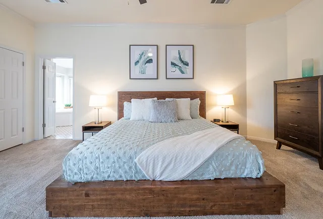 a bedroom with a bed and wooden floor