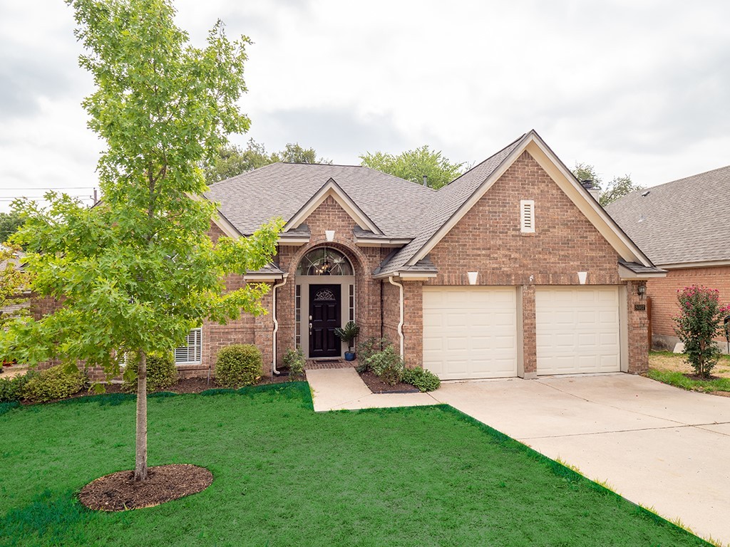 8007 Isaac Pryor Drive Austin, TX 78749 - Photo 2 of 38 a front view of a house with a yard and trees