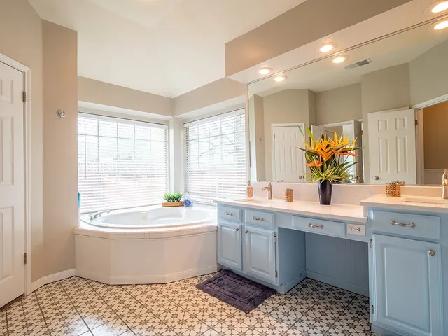 a bathroom with a sink a bathtub and a window