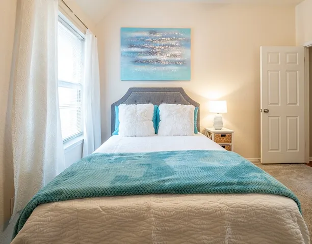 a bedroom with a bed and a window