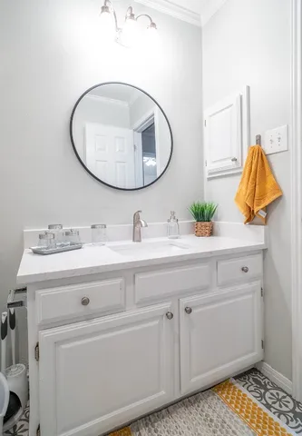 a bathroom with a sink and mirror
