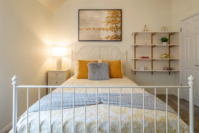 a bedroom with a bed and a window