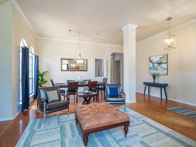 a living room with furniture and wooden floor