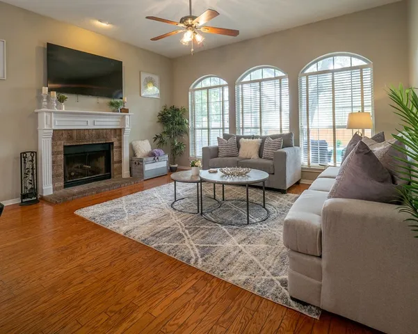 a living room with furniture fireplace and flat screen tv