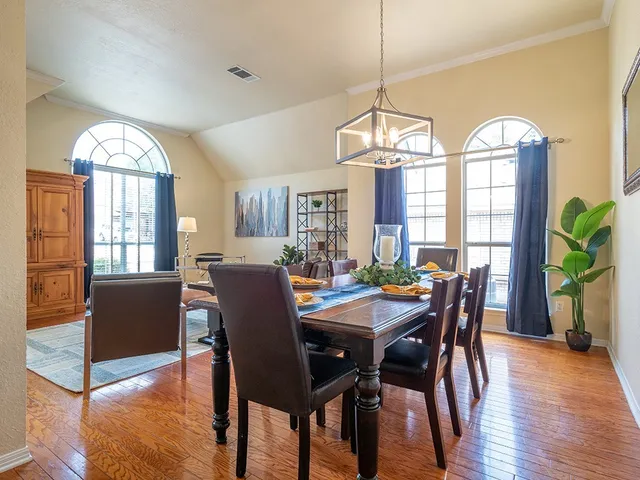 a view of a dining room with furniture window and wooden floor