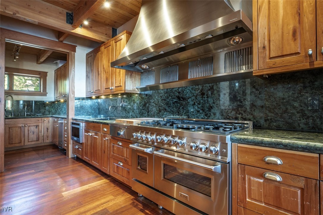951 Divot Court Incline Village, NV 89451 - Photo 23 of 50 a kitchen with stainless steel appliances granite countertop a stove a sink and a microwave