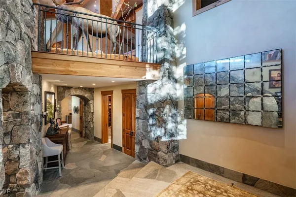 a living room with furniture fireplace and a large window