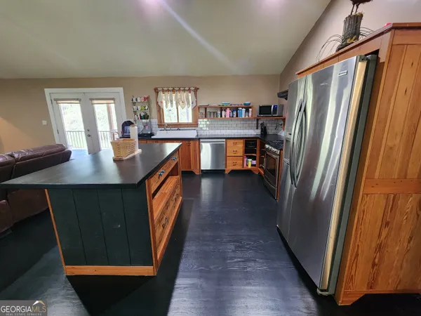 a kitchen with stainless steel appliances granite countertop refrigerator stove and sink