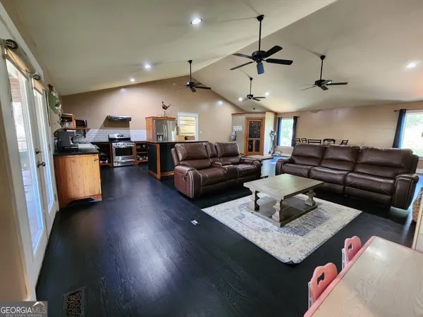 a living room with furniture and a wooden floor