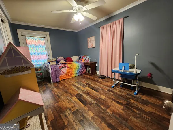 a bedroom with furniture and a window