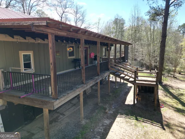 a view of a house with backyard porch and sitting area