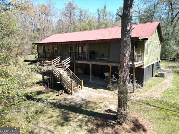 a view of house with a yard
