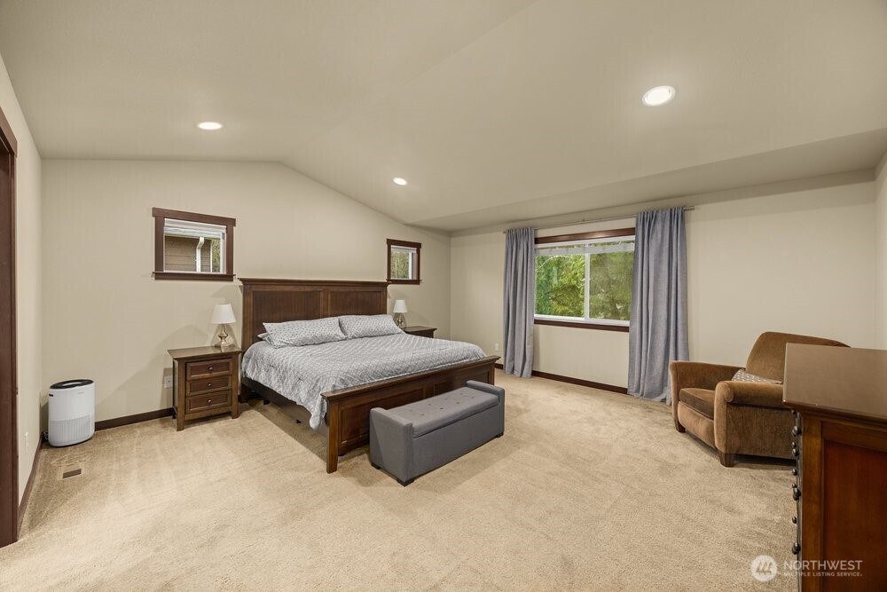 424 Barry Loop Mount Vernon, WA 98274 - Photo 13 of 23 a spacious bedroom with a bed and a couch