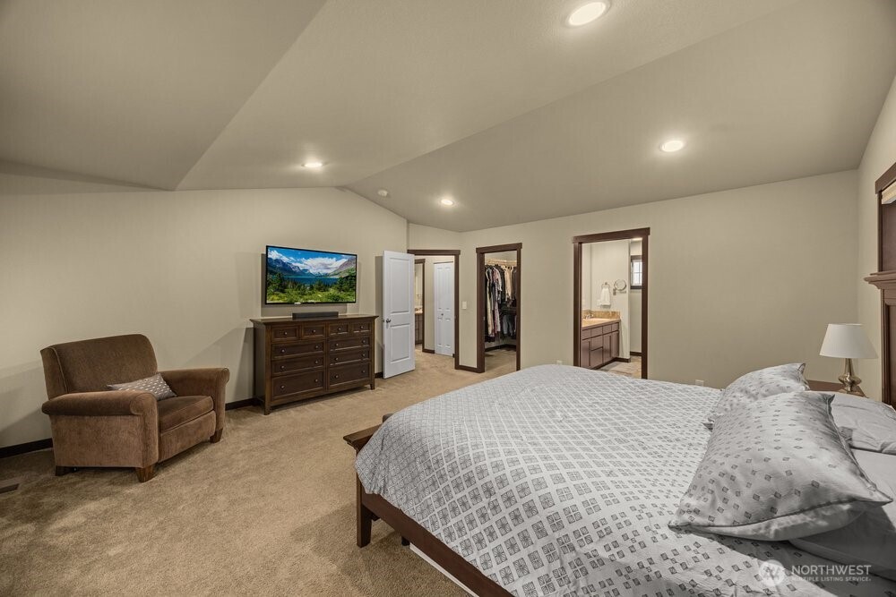 424 Barry Loop Mount Vernon, WA 98274 - Photo 14 of 23 a spacious bedroom with a bed and a chair