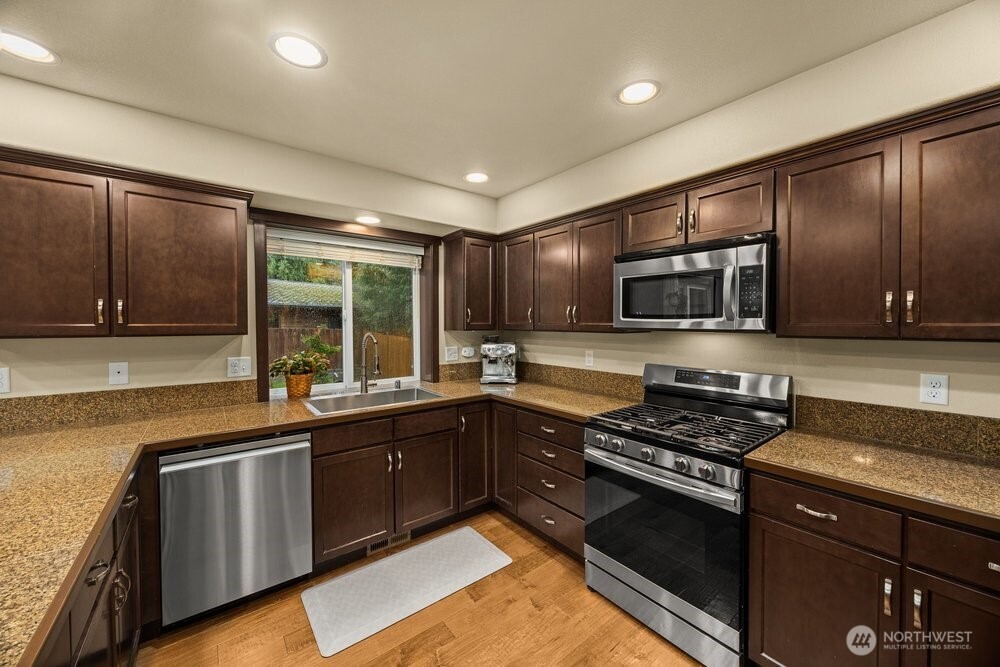 424 Barry Loop Mount Vernon, WA 98274 - Photo 7 of 23 a kitchen with stainless steel appliances granite countertop a stove and a sink