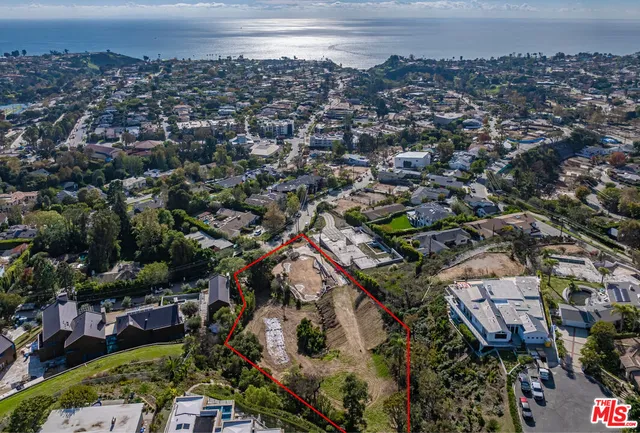 an aerial view of a city and mountain view in back