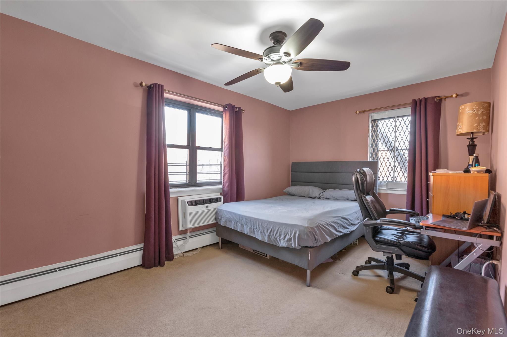 99-11 60th Avenue, Unit 5D Queens, NY 11368 - Photo 13 of 19 a bedroom with a bed and a chandelier