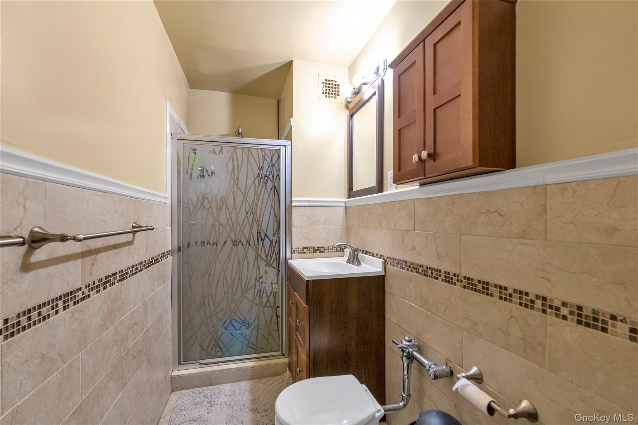 99-11 60th Avenue, Unit 5D Queens, NY 11368 - Photo 14 of 19 a bathroom with a sink toilet and shower