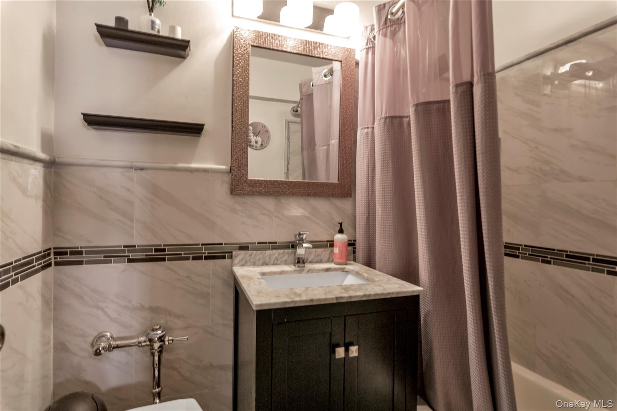 99-11 60th Avenue, Unit 5D Queens, NY 11368 - Photo 15 of 19 a bathroom with a sink and mirror