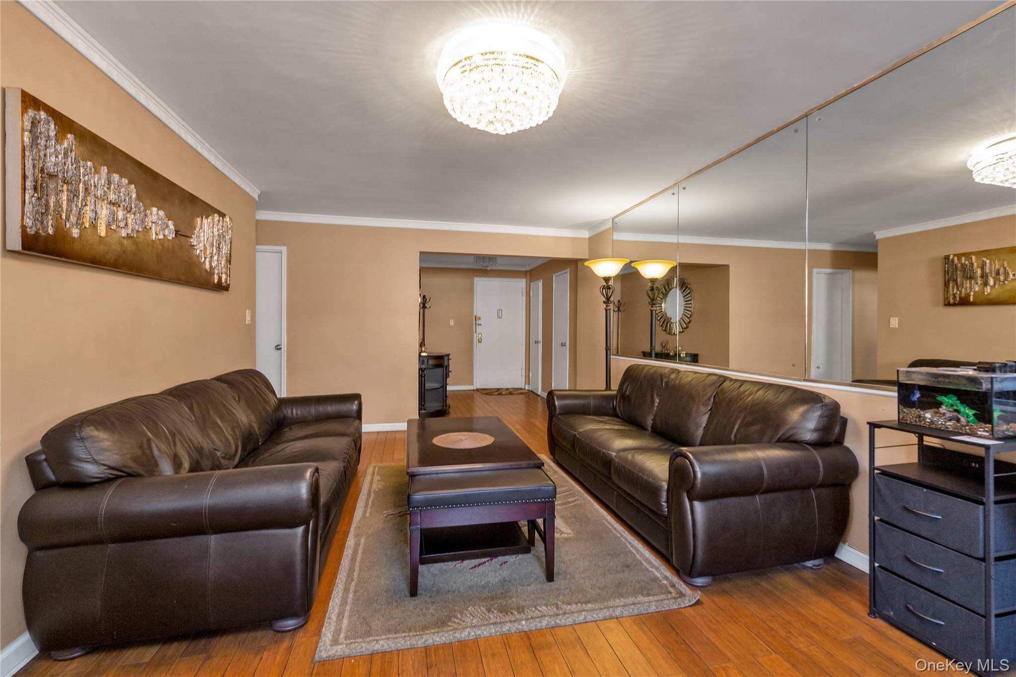 99-11 60th Avenue, Unit 5D Queens, NY 11368 - Photo 5 of 19 a living room with furniture and a wooden floor