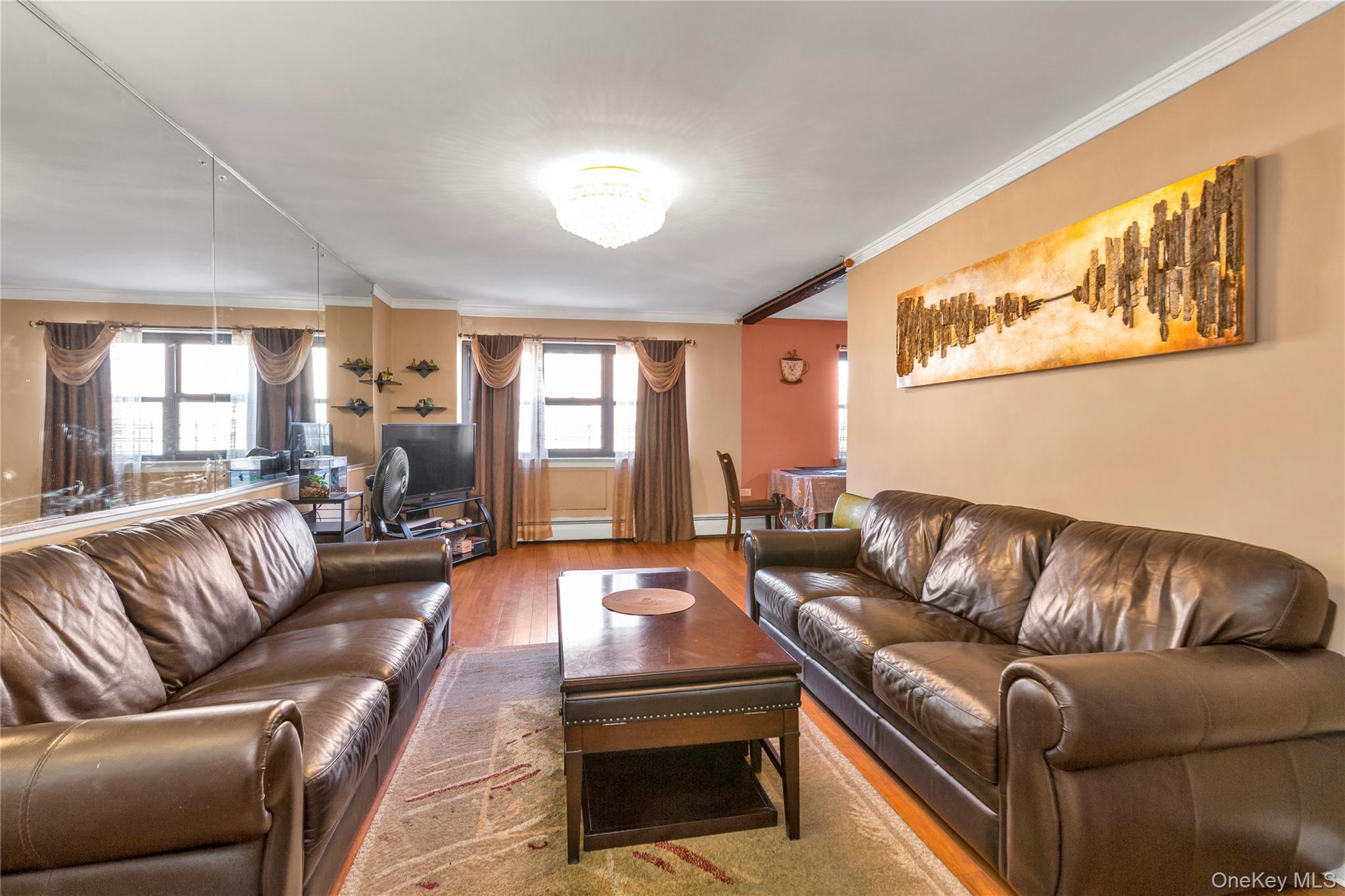 99-11 60th Avenue, Unit 5D Queens, NY 11368 - Photo 6 of 19 a living room with furniture and a large window