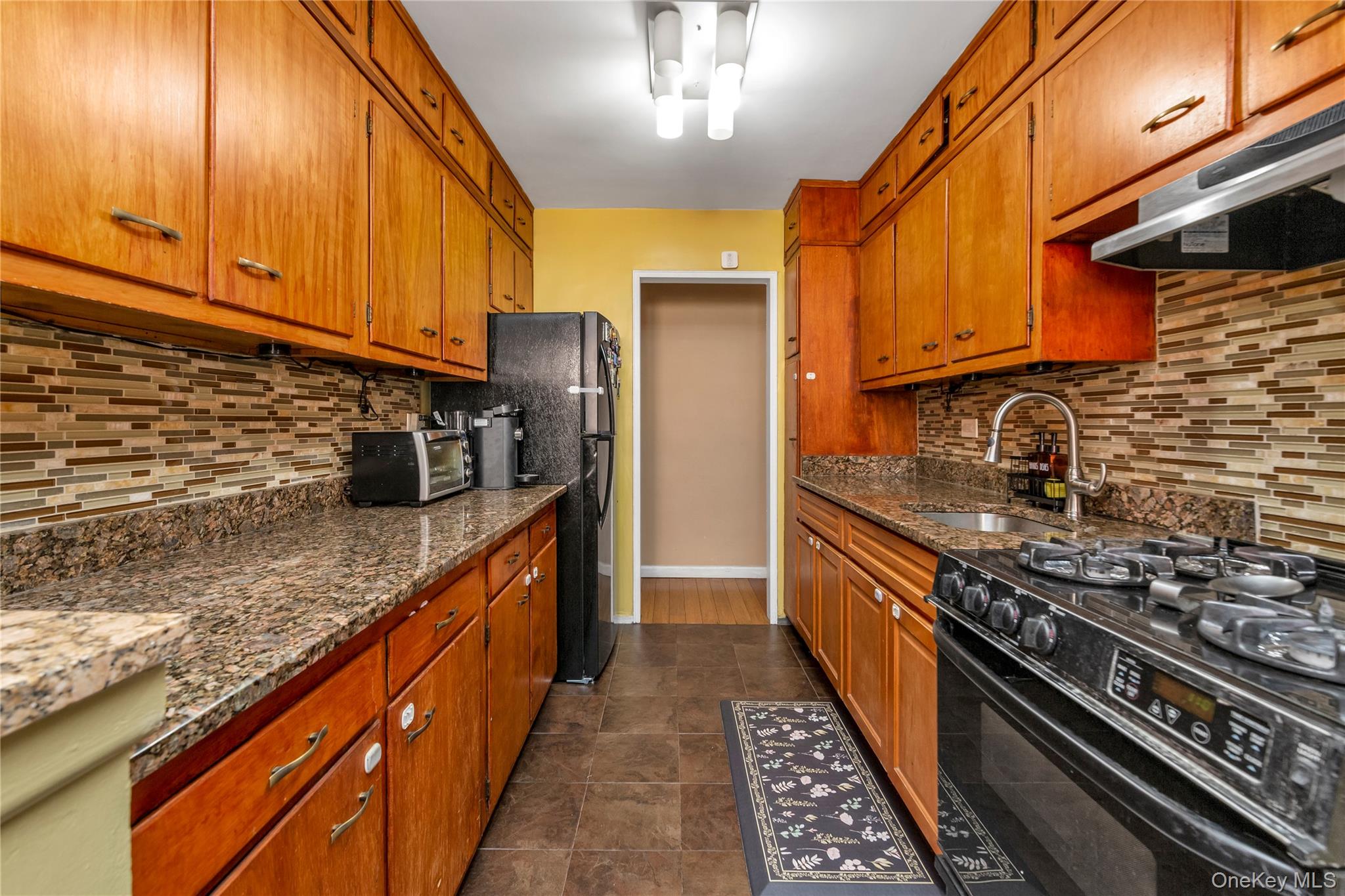 99-11 60th Avenue, Unit 5D Queens, NY 11368 - Photo 10 of 19 a kitchen with stainless steel appliances granite countertop a stove a sink dishwasher and refrigerator