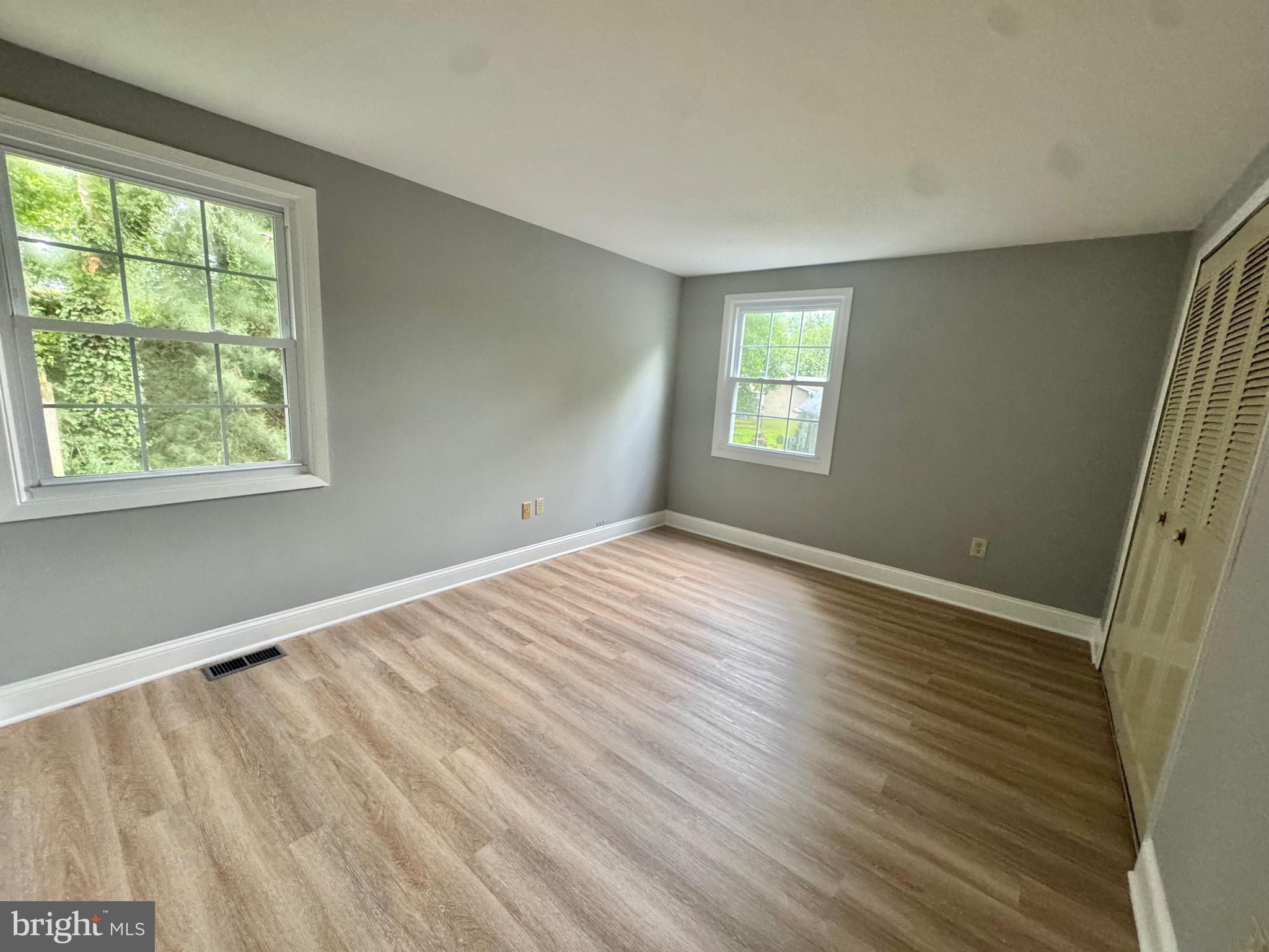 4908 Rocky Spring Lane Bowie, MD 20715 - Photo 29 of 36 a view of an empty room with wooden floor and a window