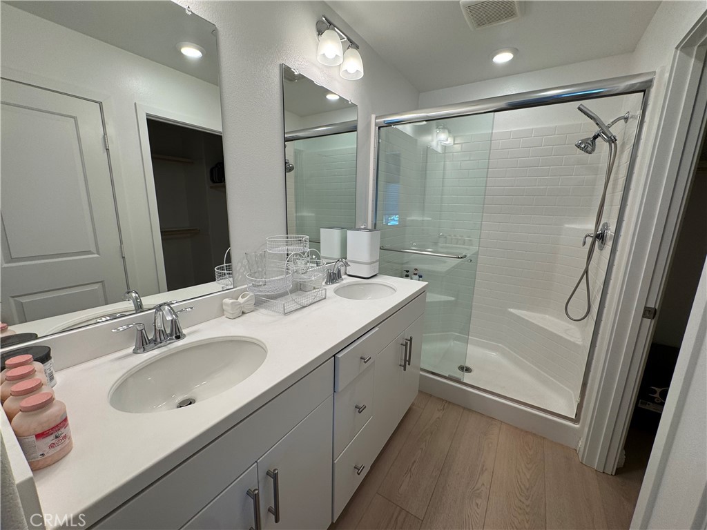18632 Rorimer Street La Puente, CA 91744 - Photo 18 of 30 a bathroom with a double vanity sink mirror double and shower