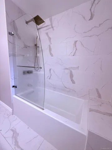 a bathroom with a bathtub and a shower