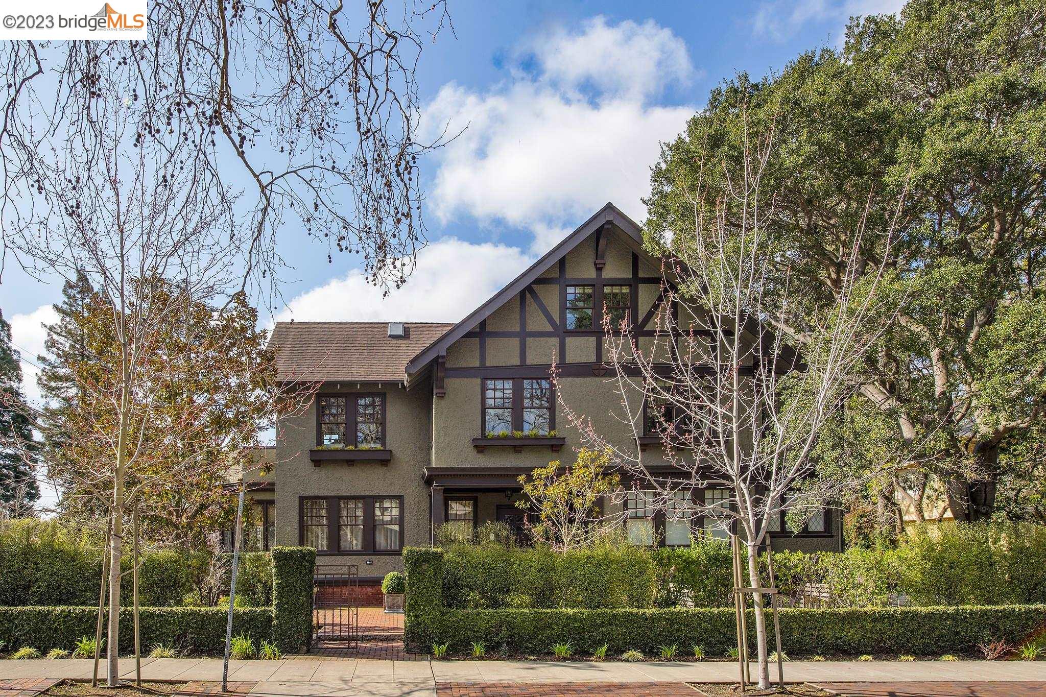 a view of a big house with a tree in the background