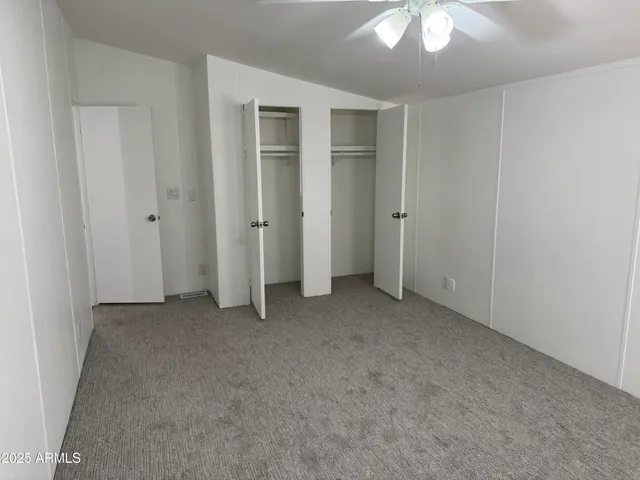 an empty room with a ceiling fan