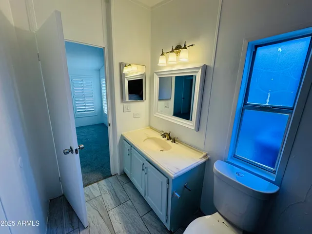 a bathroom with a toilet a sink and mirror