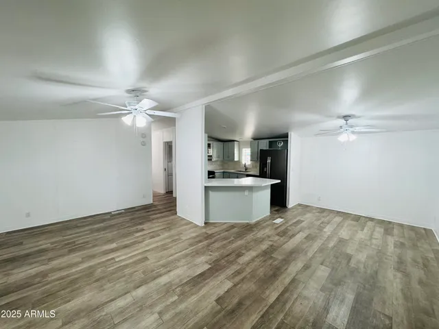 a view of a kitchen with a sink cabinets and wooden floor