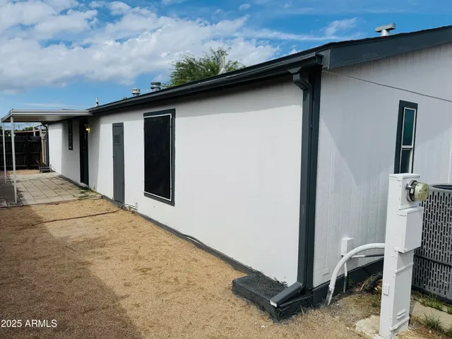 a backyard of a house with table and chairs