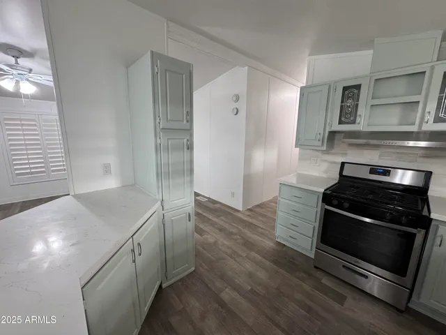 a kitchen with stainless steel appliances granite countertop a stove and a refrigerator