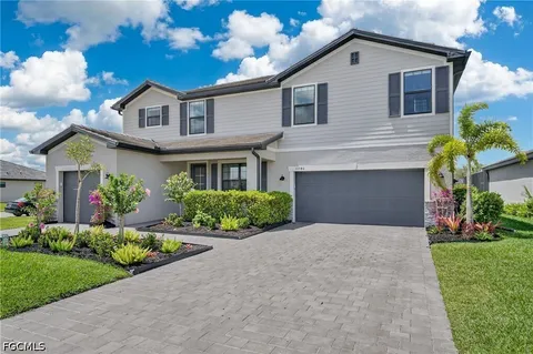 a living room with furniture a chandelier and a flat screen tv