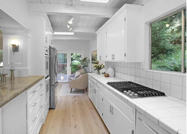 a kitchen with sink stove and cabinets