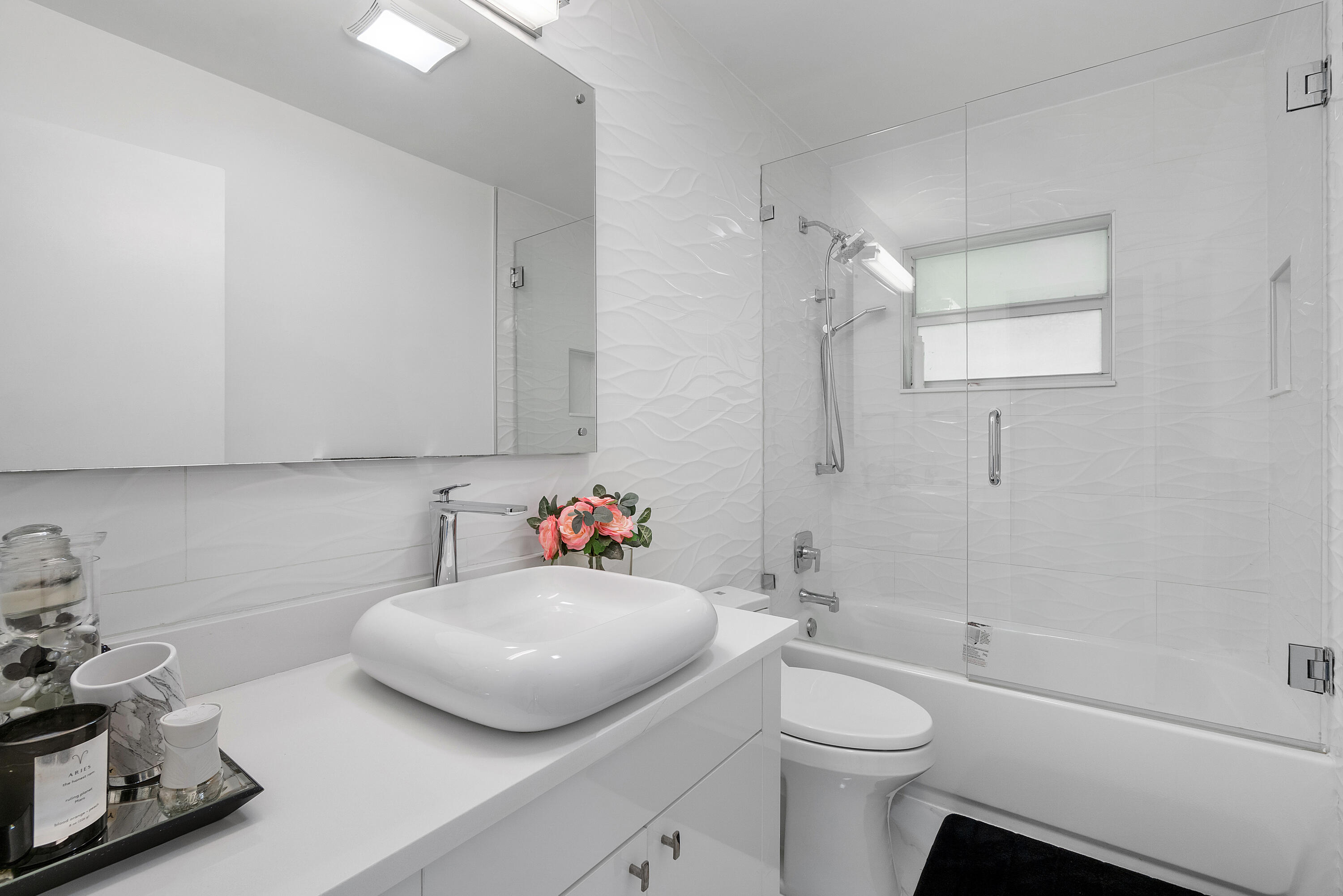 5447 Center Street Jupiter, FL 33458 - Photo 27 of 60 a bathroom with a sink toilet vanity and tub