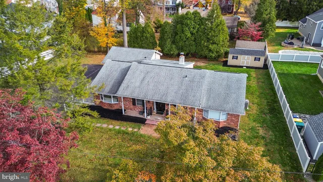 an aerial view of a house with a big yard