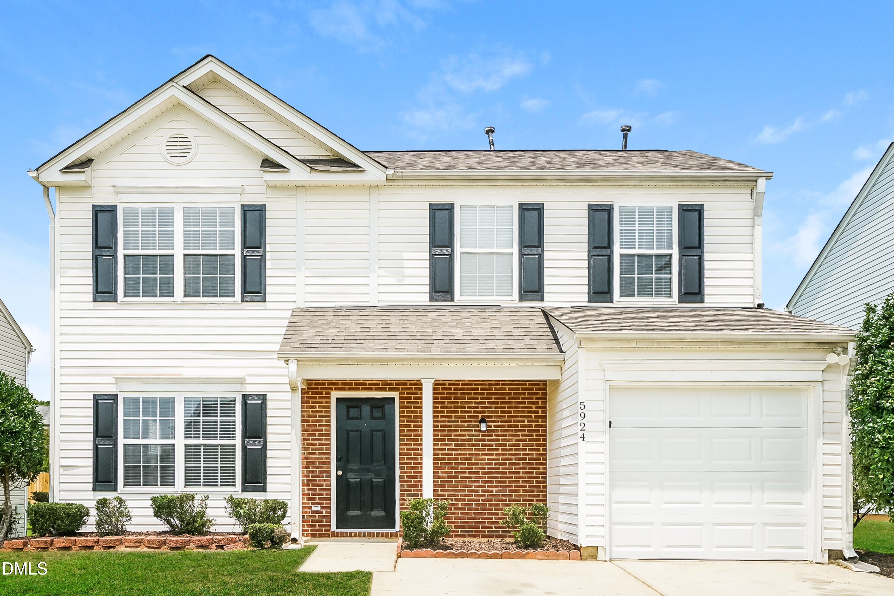 a view of a house with a yard and front view of a house