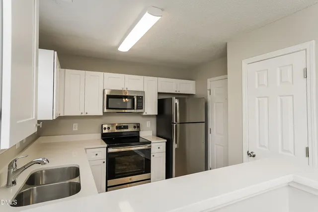 a kitchen with a refrigerator sink and microwave