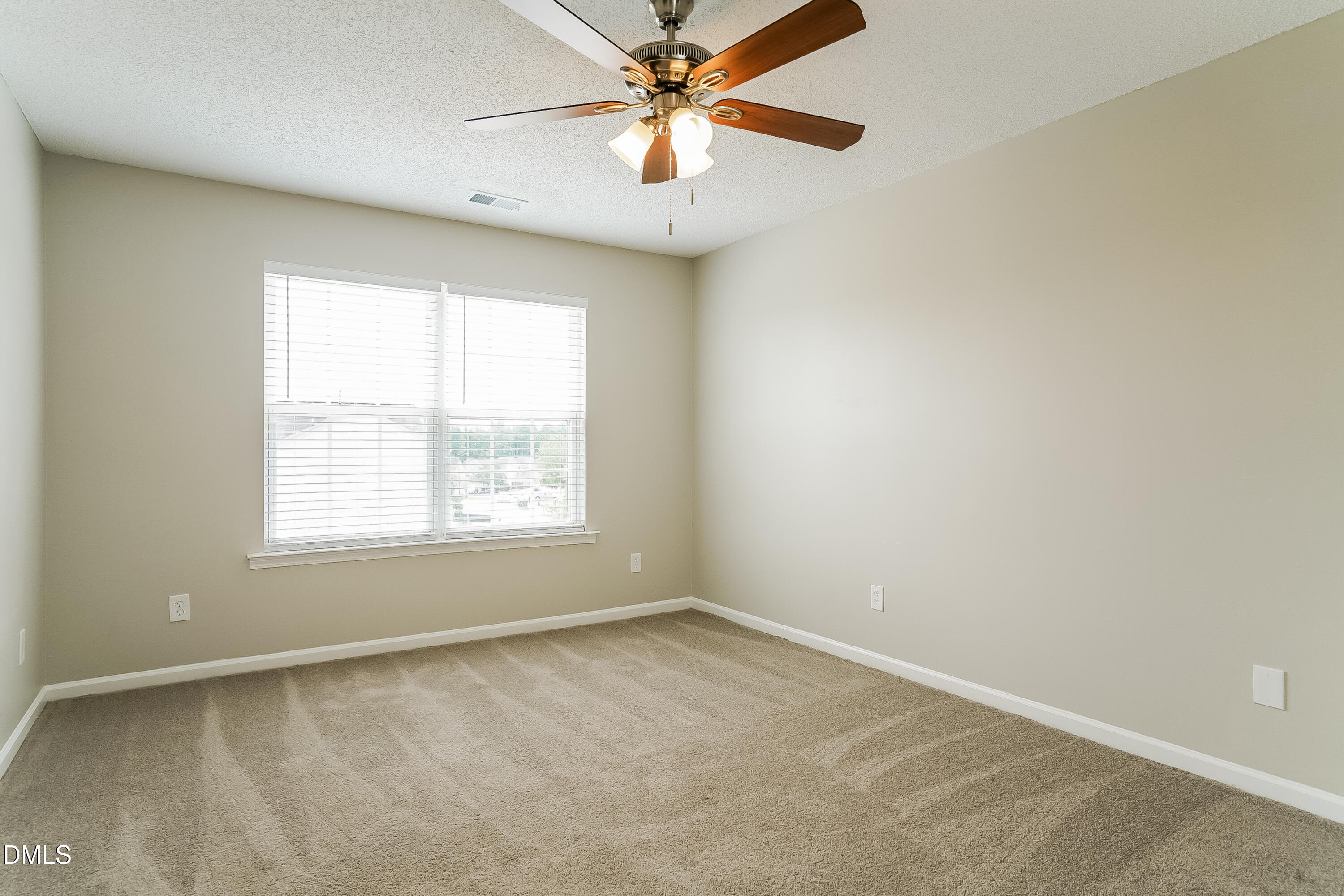 5924 Roteny Court Raleigh, NC 27610 - Photo 7 of 17 an empty room with windows and fan