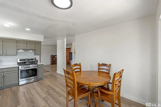 a dining room with furniture and wooden floor