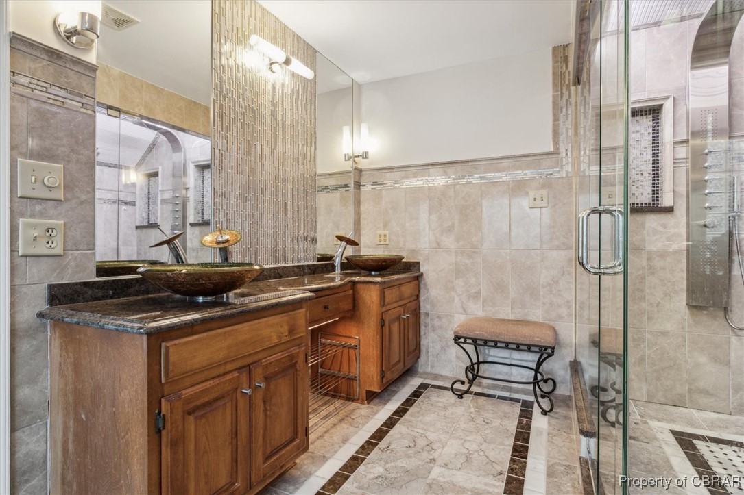 1318 Showalter Road Yorktown, VA 23692 - Photo 25 of 47 Bathroom with vanity, a shower with door, and tile walls
