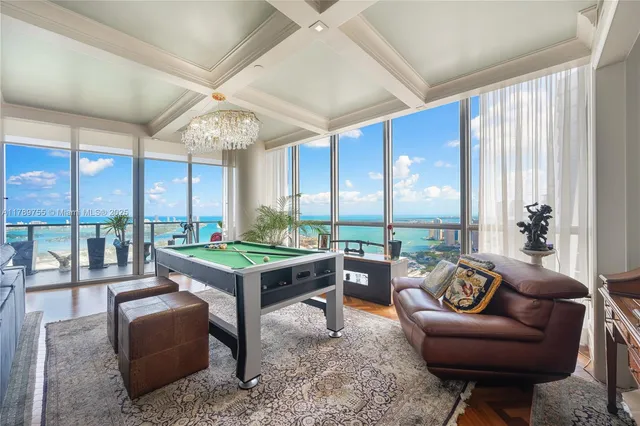 a living room with patio furniture and a large window