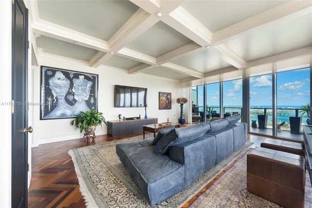 a large white kitchen with a large window and stainless steel appliances