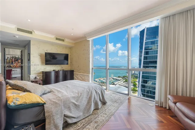a living room with furniture a rug and a painting on the wall